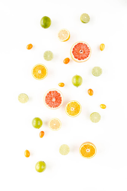 Creative pattern made of summer tropical fruits: grapefruit, orange, lemon, lime and leaves ficus. Food concept. flat lay, top view - Zdjęcie, obraz