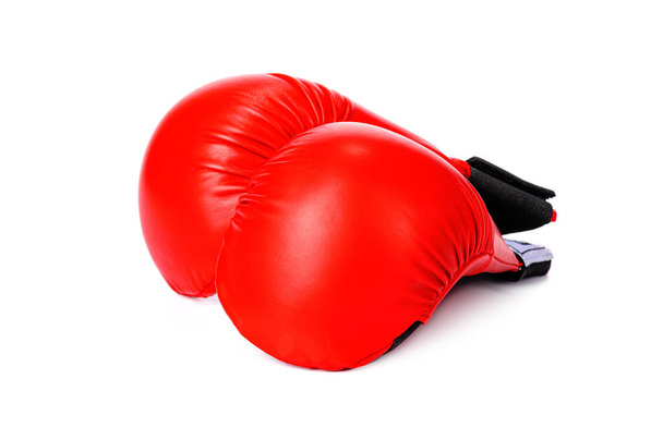 a pair of red karate gloves on a white isolated background - Photo, image