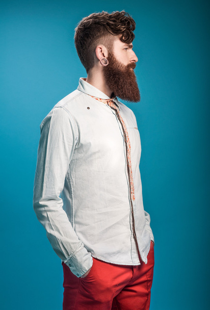 Stylish man with beard on blue background - 写真・画像