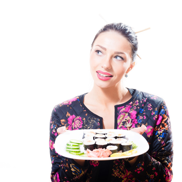 Isolated on white background portrait of pretty gorgeous brunette woman holding plate full sushi - Фото, изображение