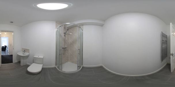 360 derece küresel panorama küresi fotoğrafı yepyeni tipik bir İngiliz banyosu köşe duşu, lavabo ve ahşap zemini olan tuvalet gösteriyor. - Fotoğraf, Görsel