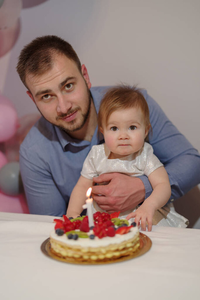 Father and daughter at her first birthday party - Photo, Image