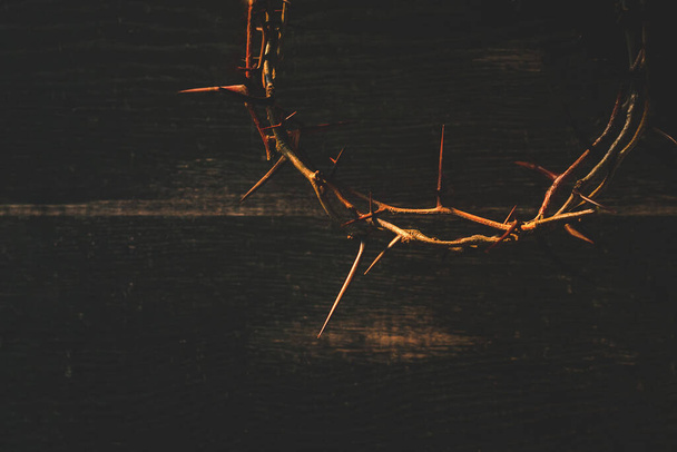 Crown of thorns on wooden table, closeup with space for text. Easter attribute - Photo, Image
