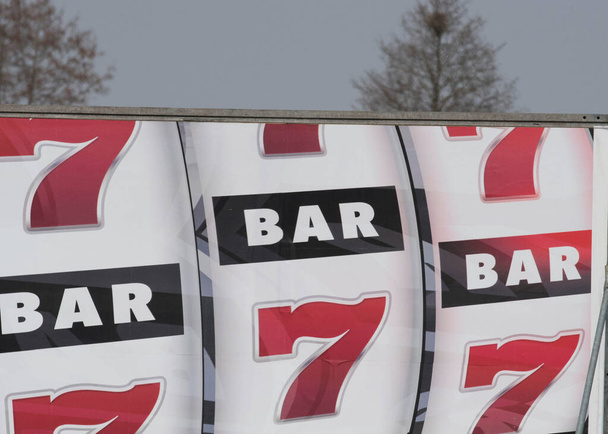 Slot machine showing "7" and "Bar" symbol, gambling and luck - Photo, Image