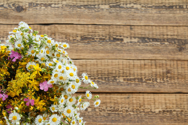 Bouquet of wildflowers on old wooden boards. Top view. - Φωτογραφία, εικόνα