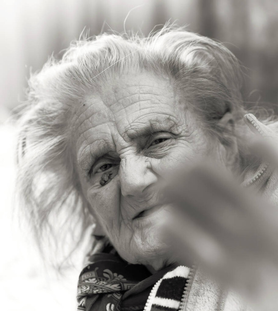 Старуха. Портрет очень старой уставшей женщины в депрессии, сидящей в помещении на кровати - Фото, изображение