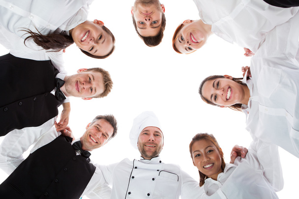 Waiters and waitresses standing in circle - Φωτογραφία, εικόνα