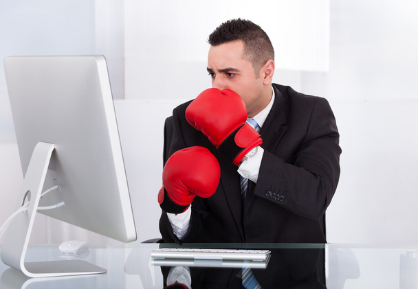 Scared Businessman With Boxing Gloves Looking At Computer - Fotó, kép