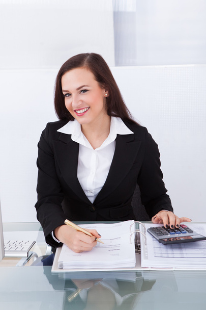 Happy Businesswoman Calculating Tax - Фото, зображення