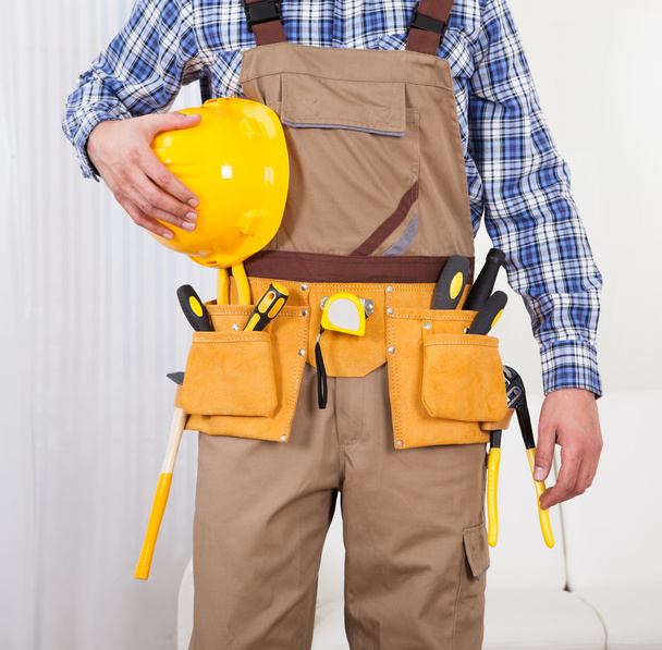 Repairman Holding Drill Machine In Living Room - Фото, изображение