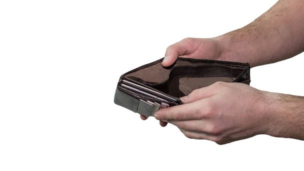 Wallet open in the hands of a man, isolated on white background, financial problems, no money in the wallet. The man looks into a wallet that has no money. - Foto, afbeelding