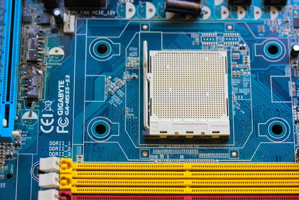 The reverse side of the colorful microboard on a blue background. Electronic board with electrical components, computer equipment.. High quality photo - Photo, Image