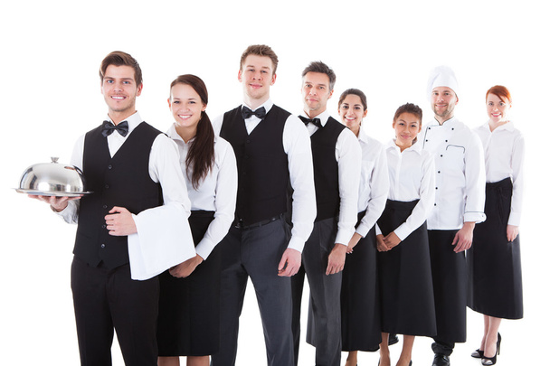 Large group of waiters and waitresses standing in row - Foto, Imagen