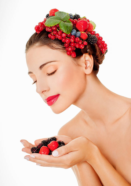 Beauty fashion model girl with fresh ripe berries. colorful berries. Beautiful makeup, juicy and sexy lips. - 写真・画像