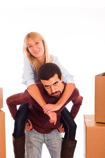 Young Couple on Moving - Man Piggybacking Woman - Photo, Image