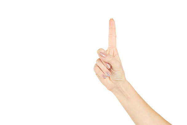 een vrouwelijke persoon toont een wijsvinger geïsoleerd op een witte achtergrond. Nummer één of eerste symbool. ideeënconcept - Foto, afbeelding