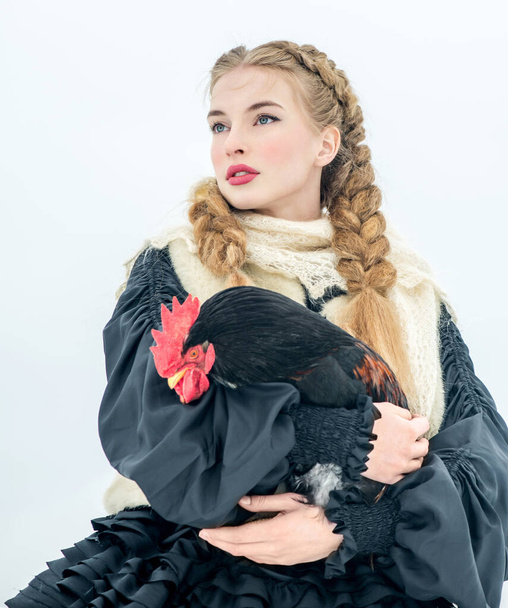 Beautiful Russian woman in a traditional dress. Russian village. Winter. - Φωτογραφία, εικόνα