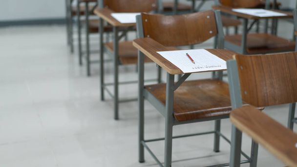 Empty university classroom with many wooden chairs. Wooden chairs well arranged in college classroom. Empty classroom with vintage tone wooden chairs. Back to school concept. - Photo, Image