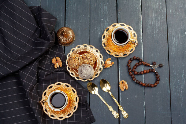 Nut balls dessert served with coffee on dark wooden table, top view - Foto, imagen