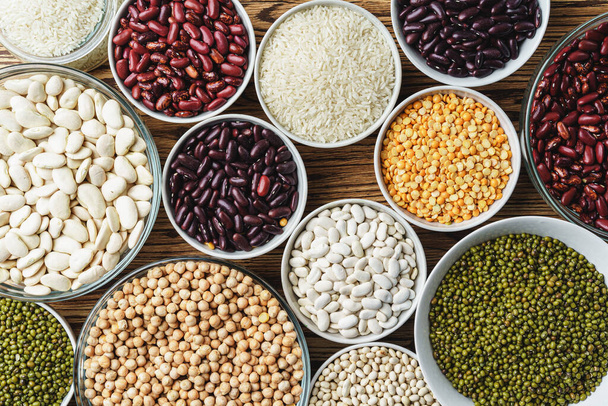 Assortment of beans on wooden background. Close up. - 写真・画像