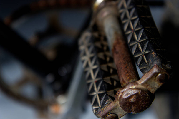A closeup shot of an old and rusty bicycle pedal on a blurred background - Foto, immagini