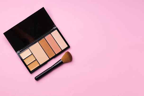 Make up palette with brush on pink background - Photo, image