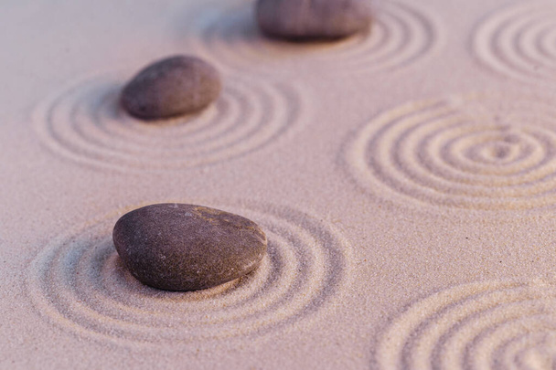 Zen garden stones on sand with ornament - Foto, afbeelding