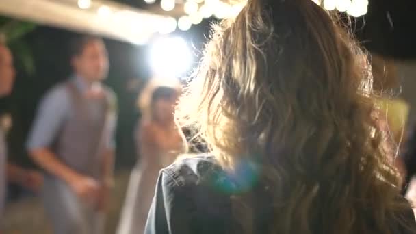 fille dansant sous les projecteurs, ses cheveux battant, vue de dos - Séquence, vidéo