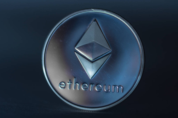 ether coin from ethereum on black background large view on blue light - Photo, Image