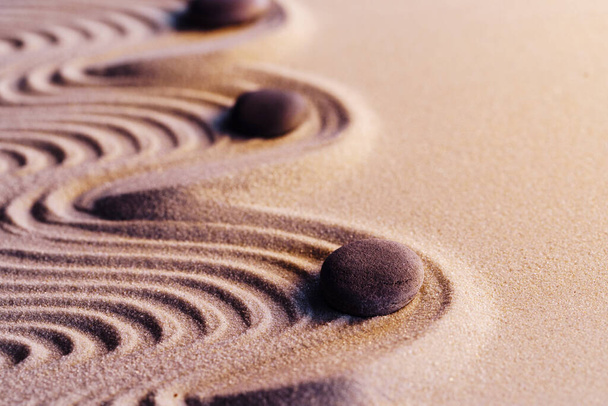 Meditation zen garden with stones on sand - Foto, afbeelding