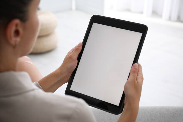 Woman using modern tablet at home, closeup. Space for design - Foto, Imagem