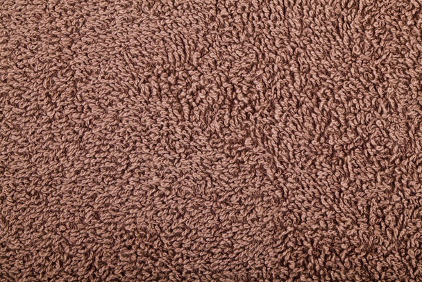Textuur van bruine badstof handdoek voor achtergrond. Prachtige creatieve stof met textiel textuur. - Foto, afbeelding