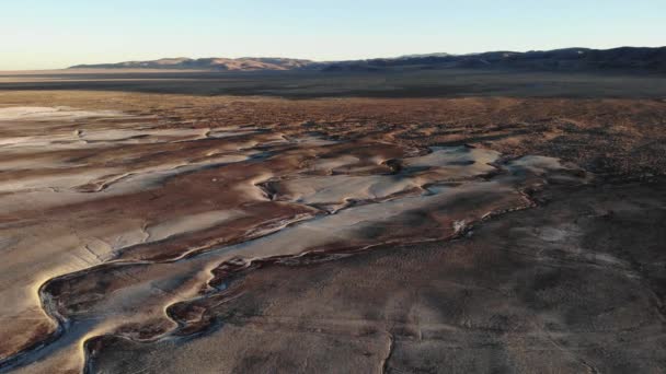 Drone flight pan left from mountains and highly textured sandy salt wells to loneliest highway 50 - Metraje, vídeo