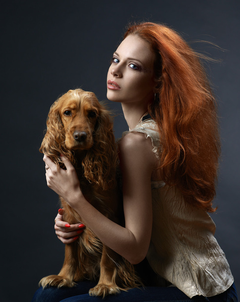 beautiful red-haired girl with a dog in the dark - Foto, Imagem