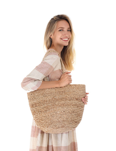 Beautiful young woman with stylish straw bag on white background - Zdjęcie, obraz