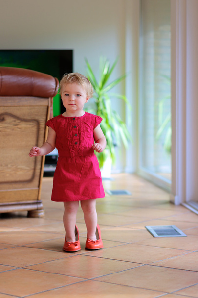 Toddler girl trying mom's shoes - Photo, image