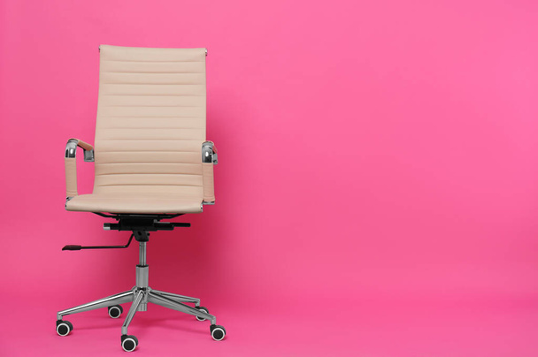 Comfortable office chair on pink background, space for text - Valokuva, kuva