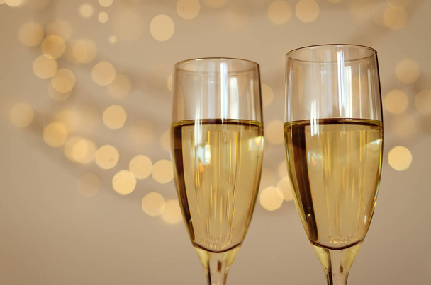 Two glasses of wine with bokeh background close up. Top view. New Year, Christmas mood. Greeting card. Party and holiday celebration concept. - Fotografie, Obrázek