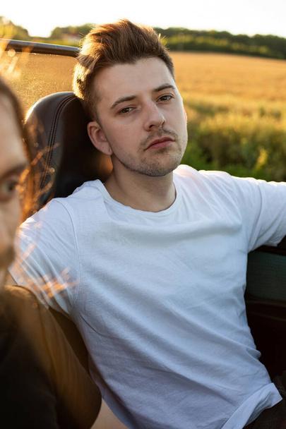 Young man with blonde hair portrait in the car - Foto, Imagem