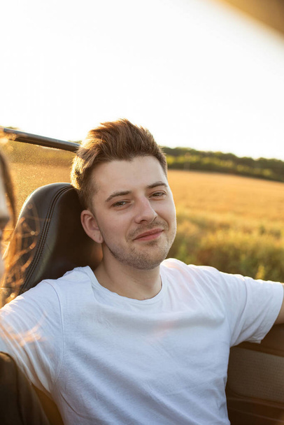 Young man with blonde hair portrait smiling in the car - Foto, immagini
