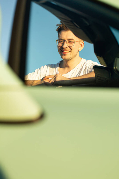 Smiling white european boy in the car in glasses - Photo, image