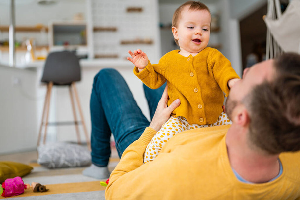 Father and daughter laughing and bonding. Daddy and his little girl spending time at home. Single dad fun love family lifestyle concept - Zdjęcie, obraz