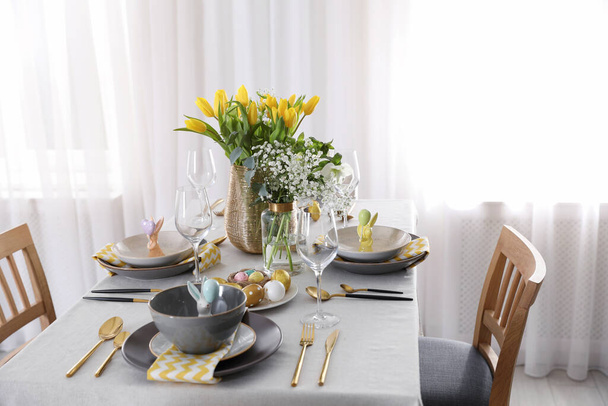 Beautiful Easter table setting with festive decor indoors - Foto, Imagen
