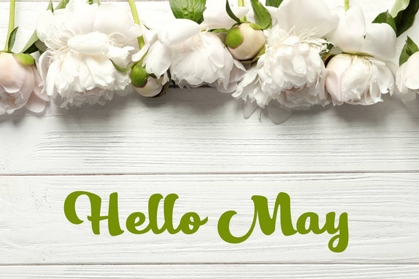 Hello May. Beautiful blooming peony flowers on wooden background, top view - Fotó, kép