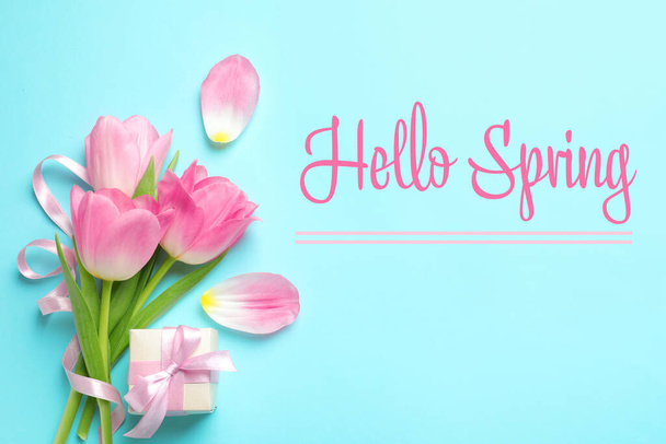 Hello Spring. Flat lay composition with beautiful tulips on light blue background - Fotó, kép