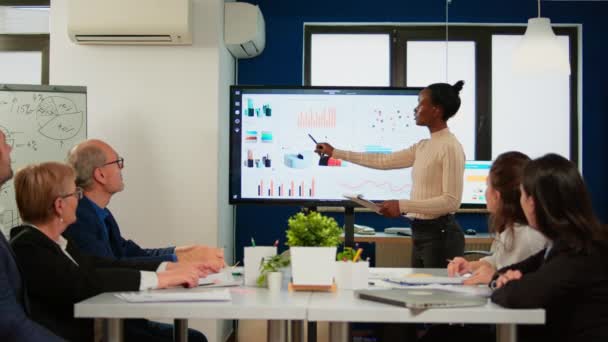 Black analyst using digital interactive whiteboard for presentation - Footage, Video
