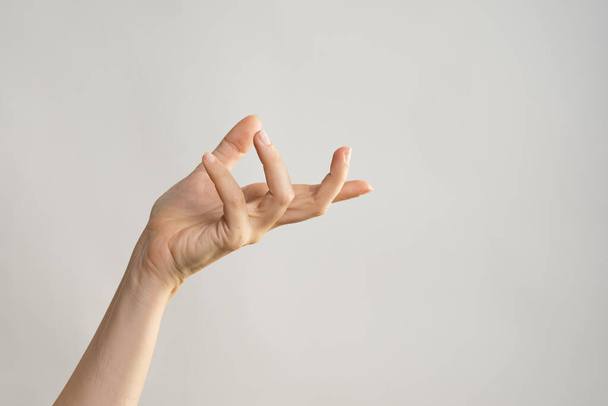 Hand gestures. Elegant female hand, pointing to the side - Foto, Imagem