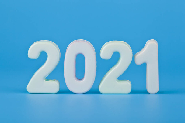 Figures 2021 on a blue background close up. Festive background for New Year and Christmas holidays. - Photo, image