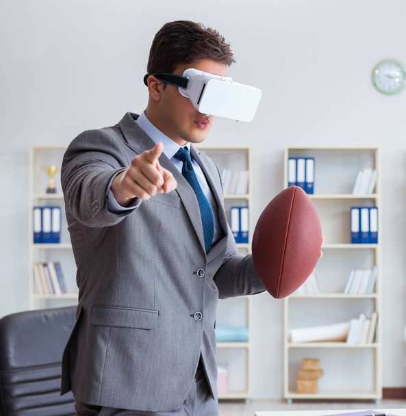 Businessman playing virtual reality football in office with VR g - Valokuva, kuva