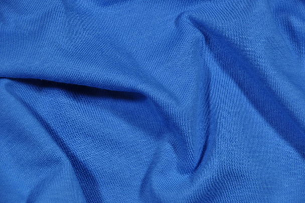 Background, texture. Blue fabric. Pleated fabric, pleats. - Фото, изображение